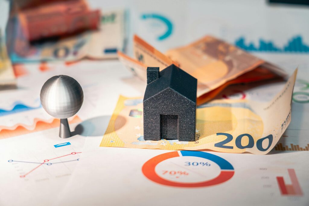 pexels-photo-27745581-27745581 Conceptual image of real estate and finance involving euro currency and data charts, symbolizing investment.