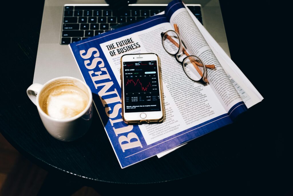 pexels-photo-7873570-7873570 A business setup with a laptop, coffee, phone, and newspaper. Perfect for finance themes.